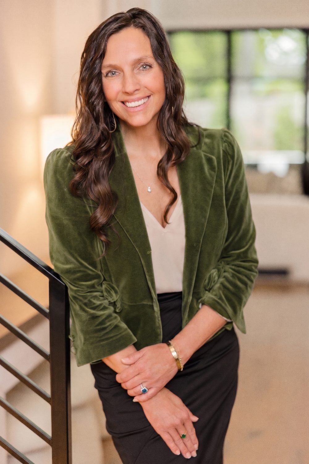Portrait of Connie Mester, founder of Mindful Moves, smiling in a green velvet blazer